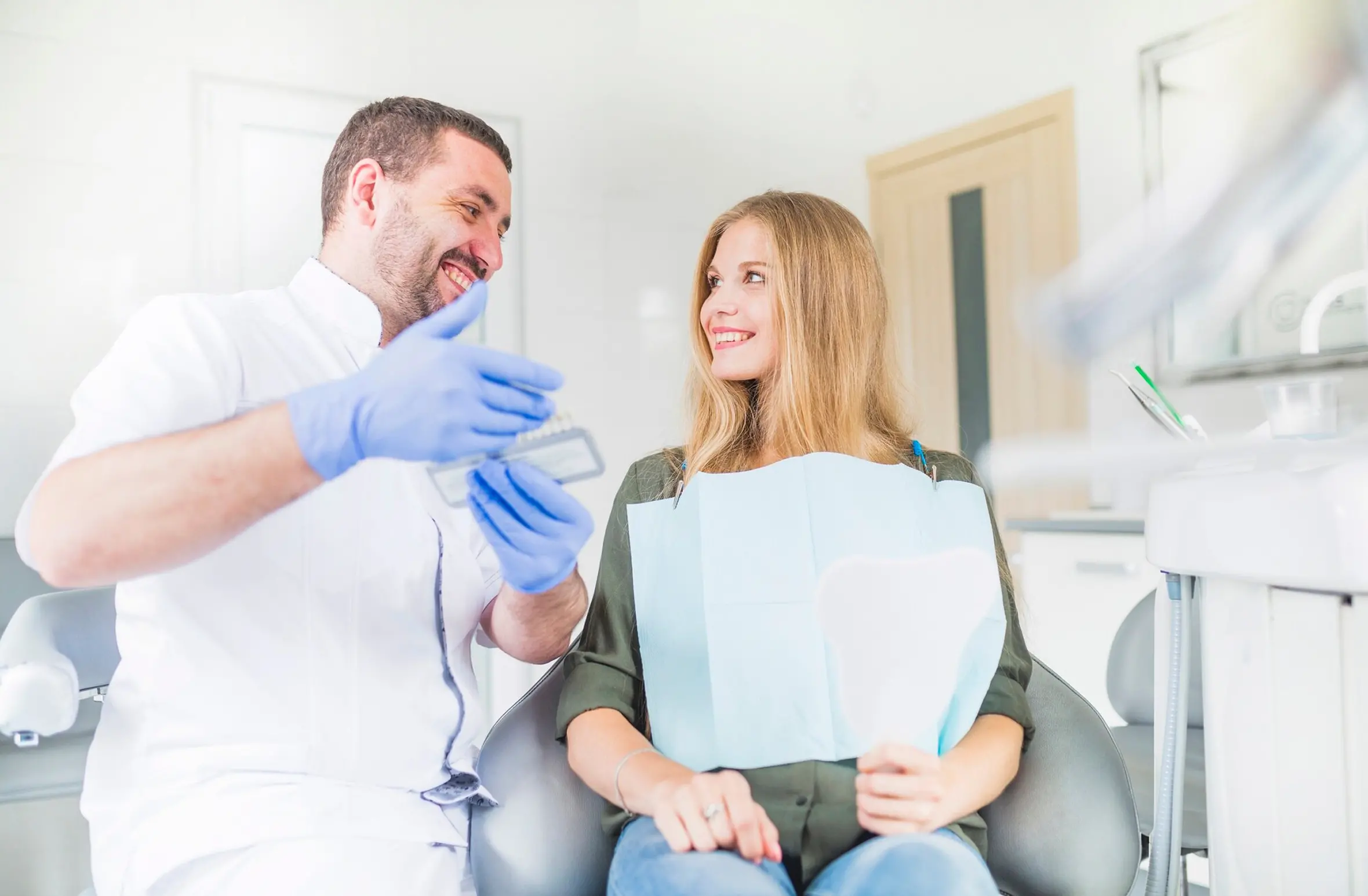 Dentist consulting with patient in dental clinic, discussing treatment options for dental tourism in Mexico, highlighting quality care and affordability.